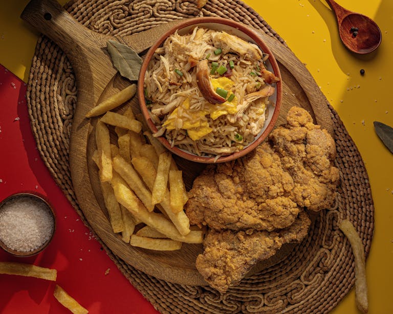 Delicious Peruvian-style fried chicken served with crispy fries and a flavorful rice bowl in Tacna, Peru.